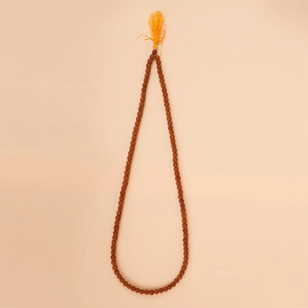 Five mukhi rudraksha mala with a yellow tassel laid in a long loop