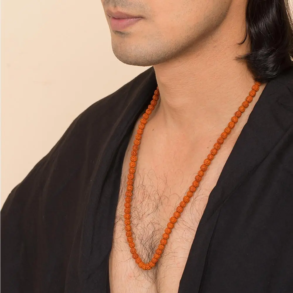 A man wearing the mala with a black shawl