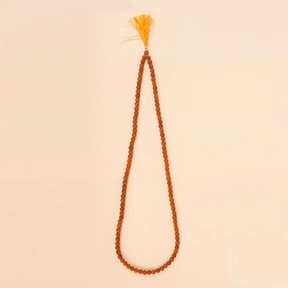 Five mukhi rudraksha mala with a yellow tassel laid in a long loop