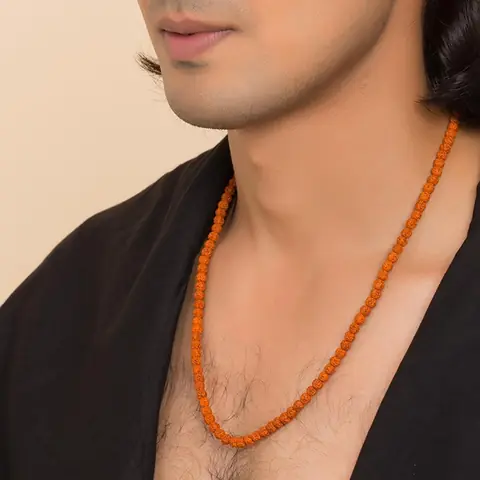 A man wearing the mala with a black shawl