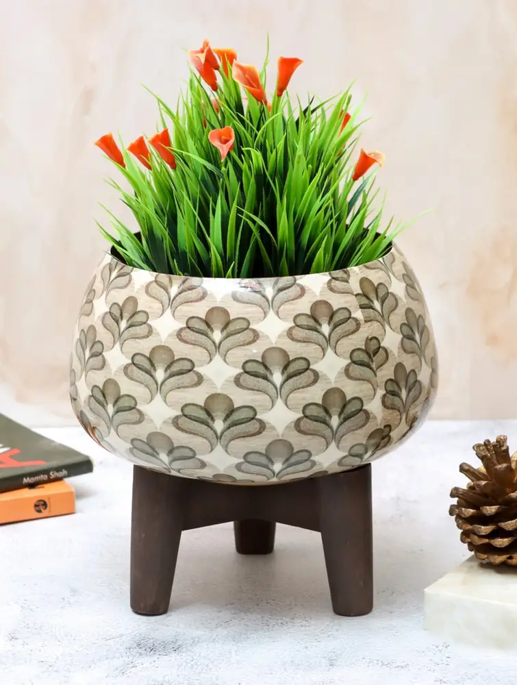 Planter with bright orange flowers on a table