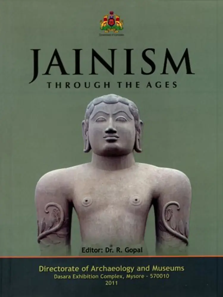 Dark green front cover of Jainism Through the Ages with a standing stone sculpture