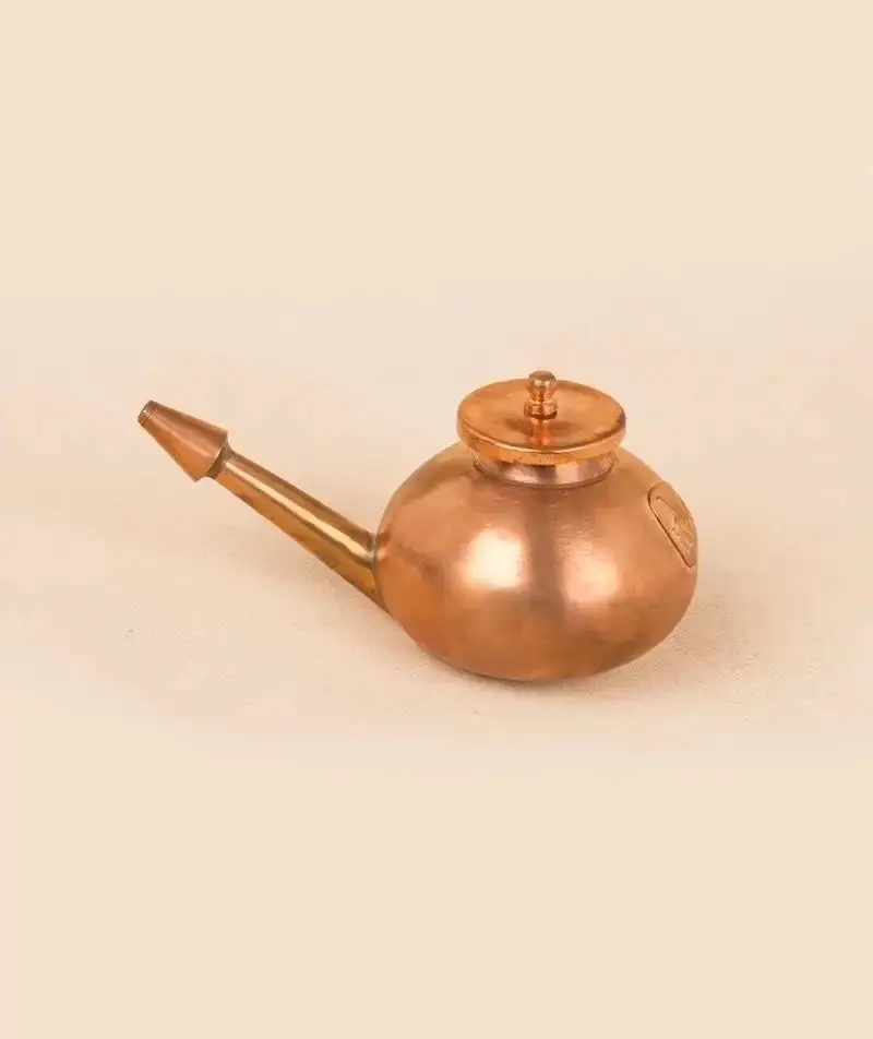 Jala Neti pot with a long spout on a plain ground