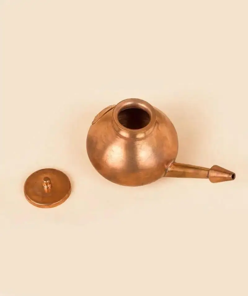 Neti pot with its lid on the side