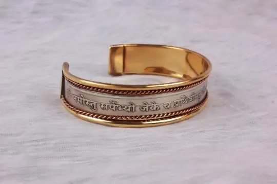 The kada from another angle showing the inscription