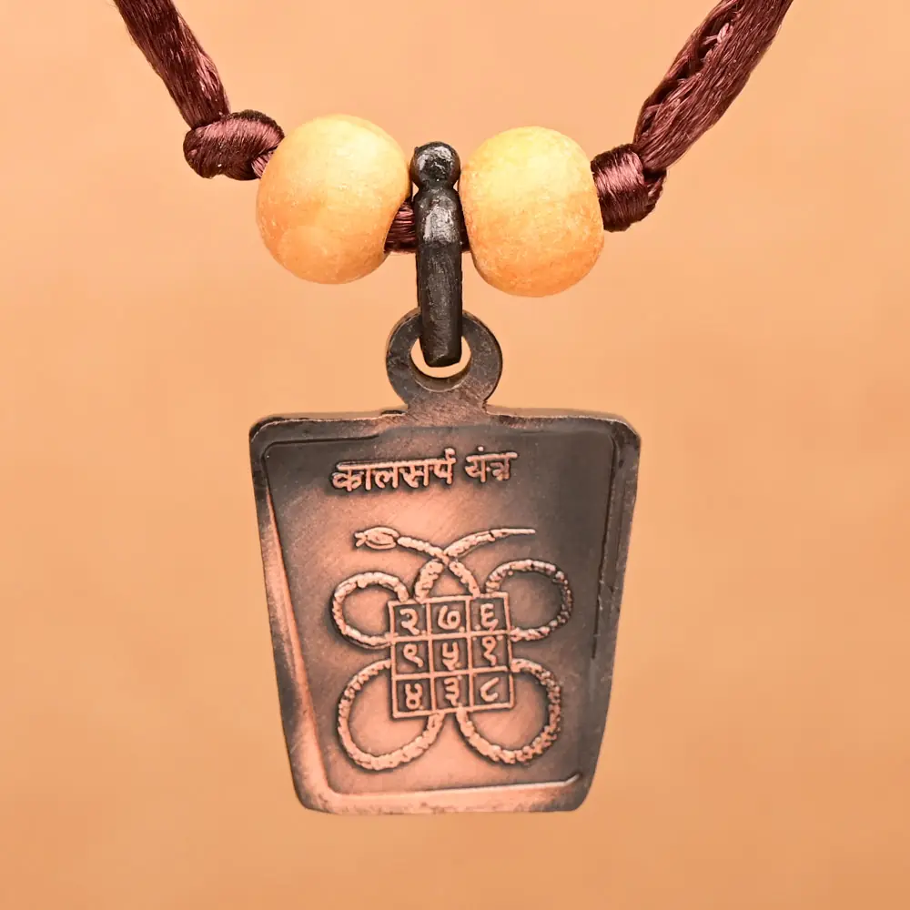 Kaal Sarp yantra side of the copper locket on a thread