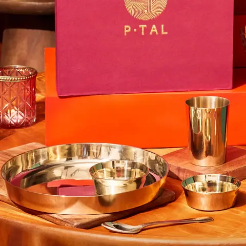 The set on an orange cloth in front of a red gift box