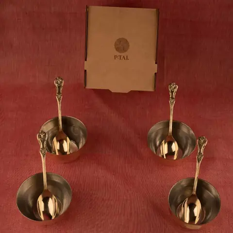 Four spoons and four bowls laid out on a red cloth