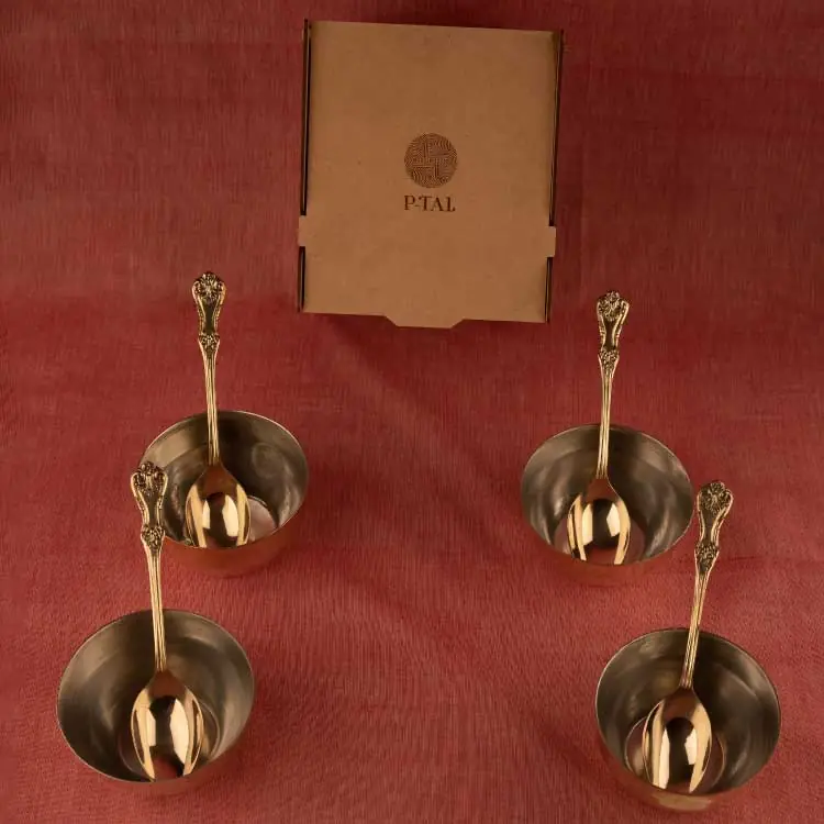 Four spoons and four bowls laid out on a red cloth