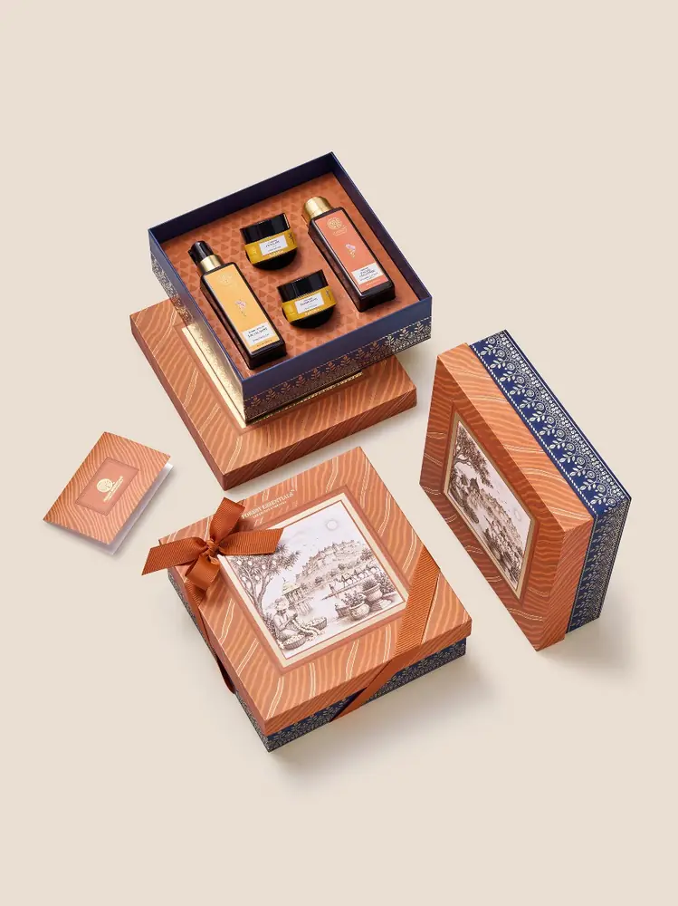 Orange Kesariya gift box with four products above it