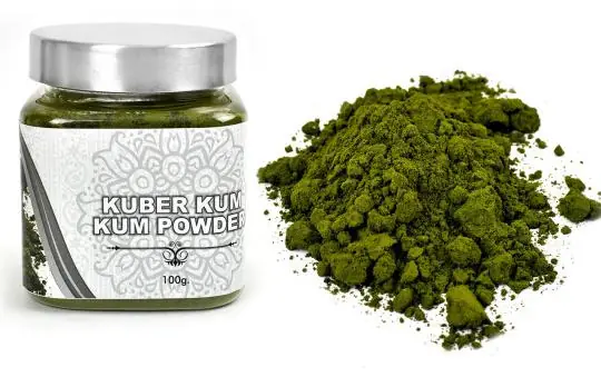 Jar of Kubera kumkum with the green powder beside it