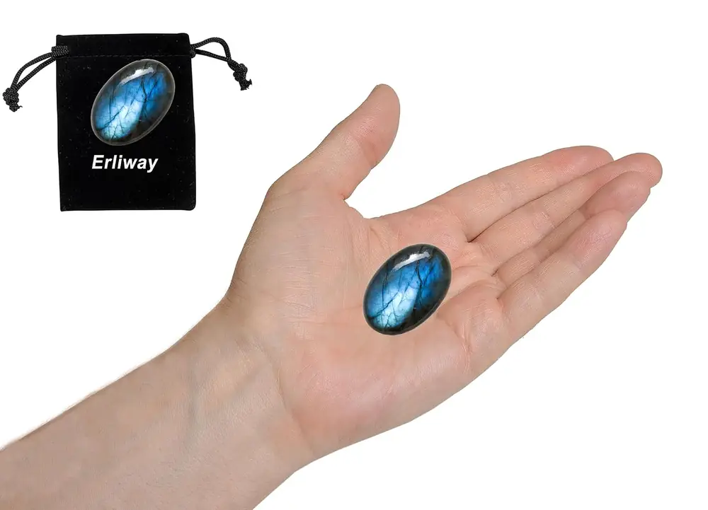 A small labradorite stone held in the palm for scale