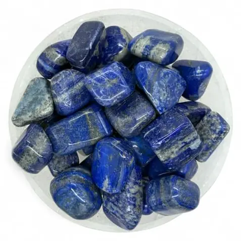 Tumbled lapis lazuli stones in a round dish