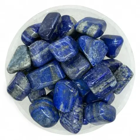Tumbled lapis lazuli stones in a round dish