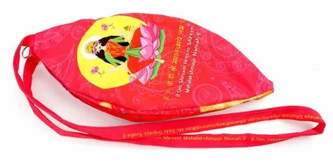 Bag with Lakshmi on a lotus, strap lying beside it