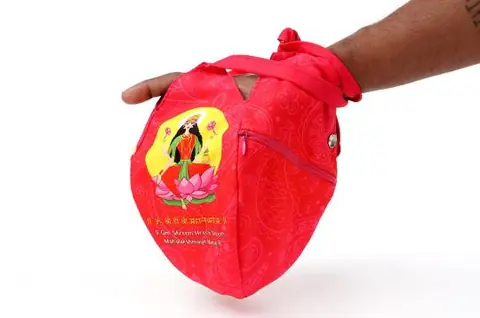 A hand holding the bag