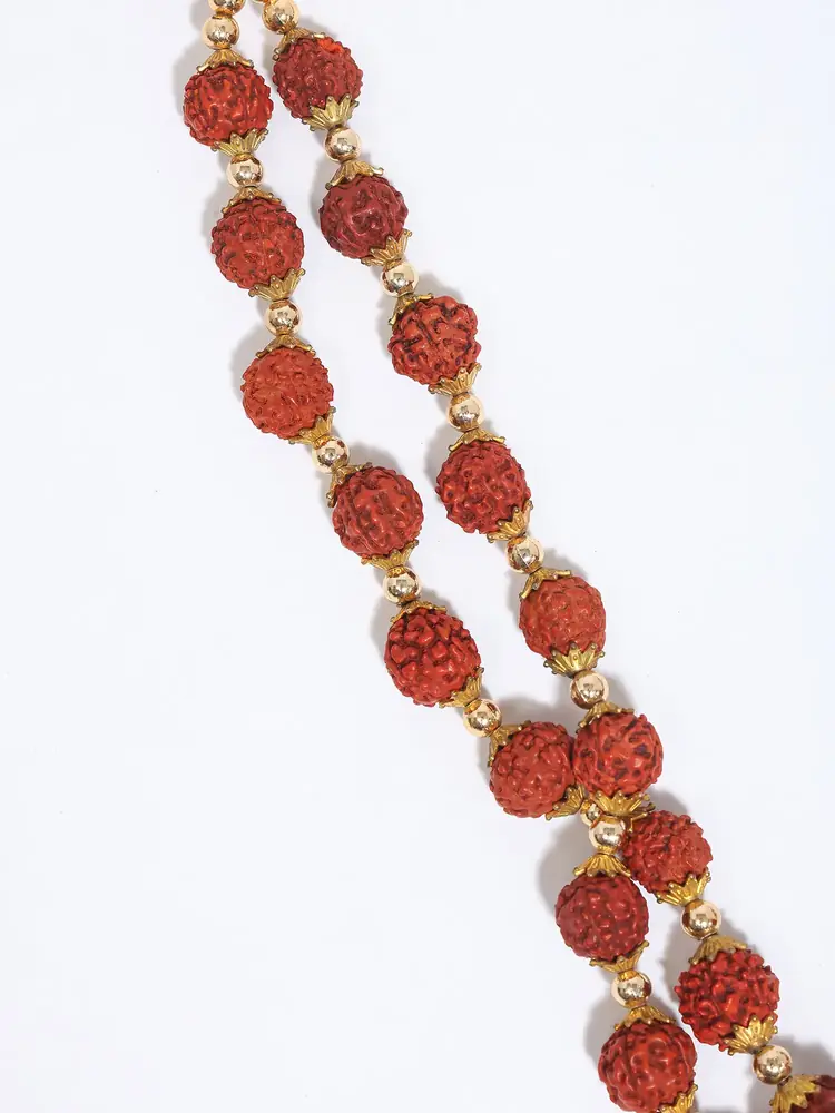 Close view of the beads and gold-coloured caps