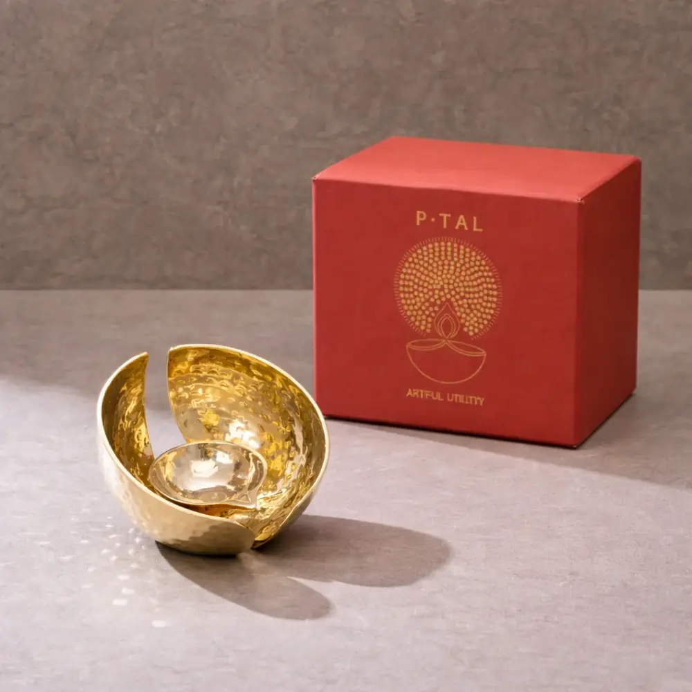 Lotus diya beside its red gift box