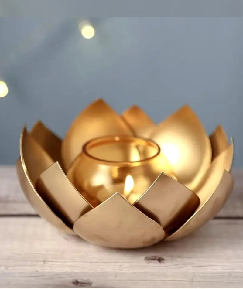 Lit tea light inside a brass-finish lotus holder