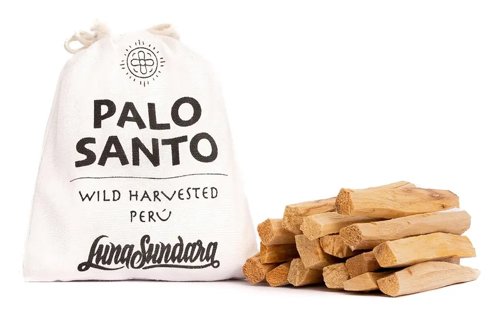 Palo santo sticks beside a cloth bag marked Palo Santo