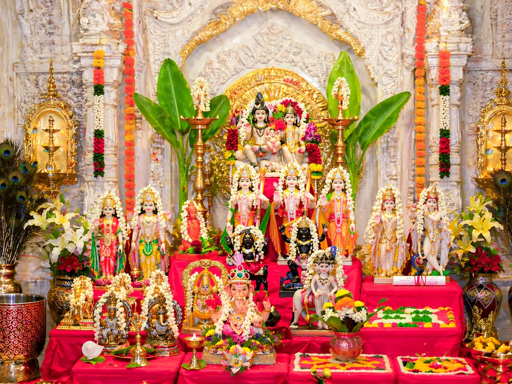 Altar with deity images, banana leaves and flowers