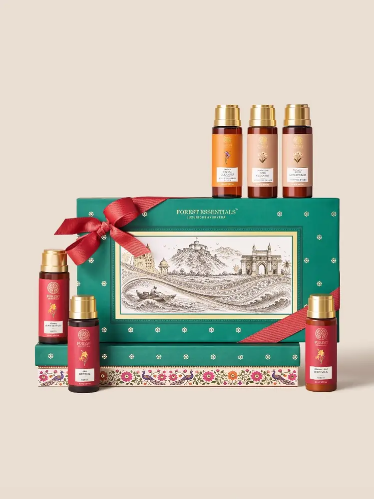 Teal Mayuri gift box with a red ribbon and six bottles