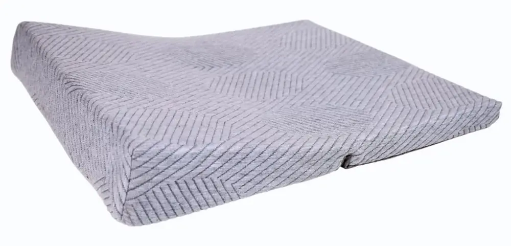 Grey wedge meditation cushion on a white ground