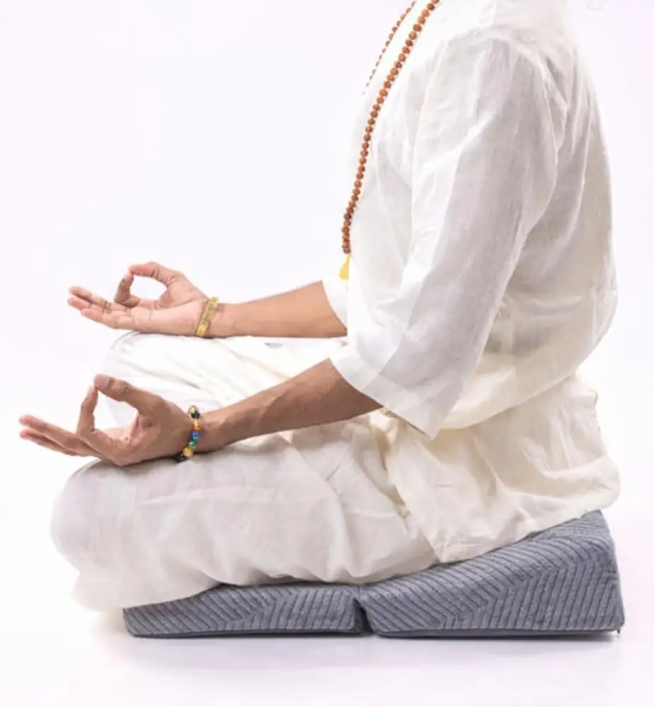 Person sitting cross legged on the cushion