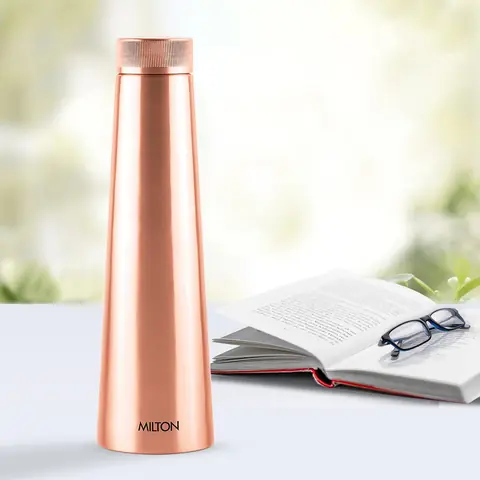 The bottle beside an open book and glasses