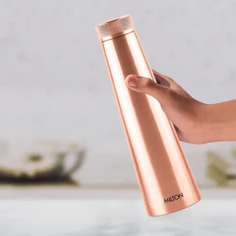 A hand holding the bottle