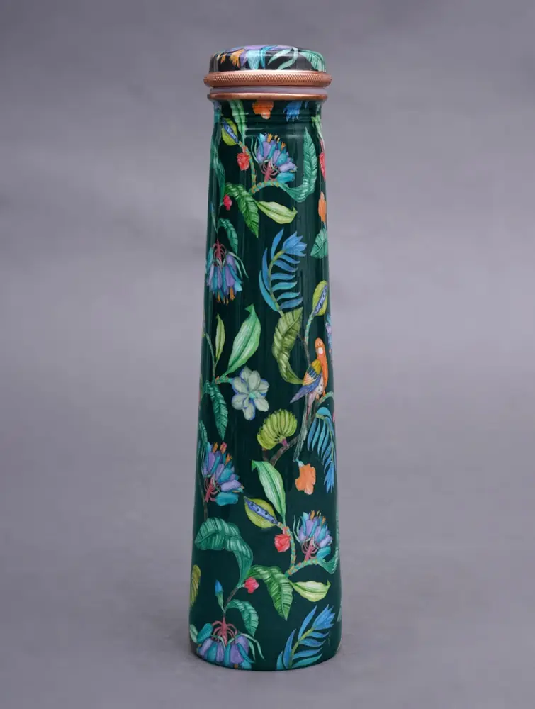 Dark green copper bottle with bird and leaf print on a plain ground