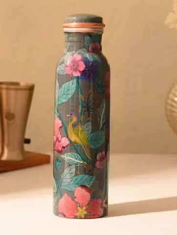 Bottle side showing a yellow bird among flowers