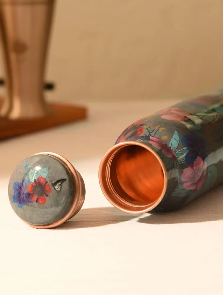 Open bottle with its matching cap and the bare copper inside
