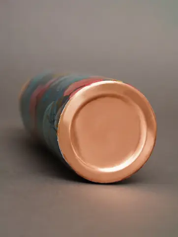 Bottle on its side with copper base