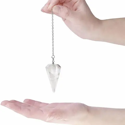 A pendulum held over an open palm