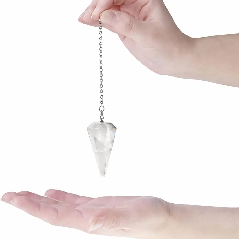 A pendulum held over an open palm