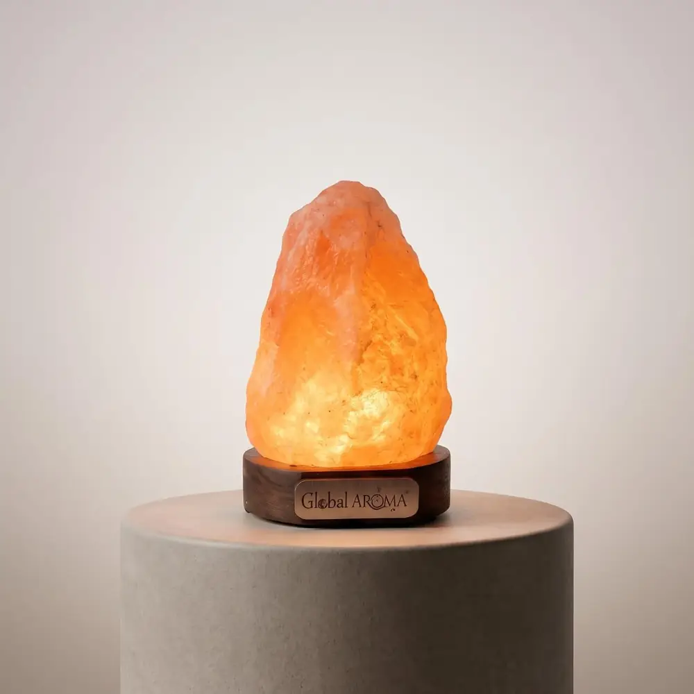 Lit orange salt lamp on a grey stone block