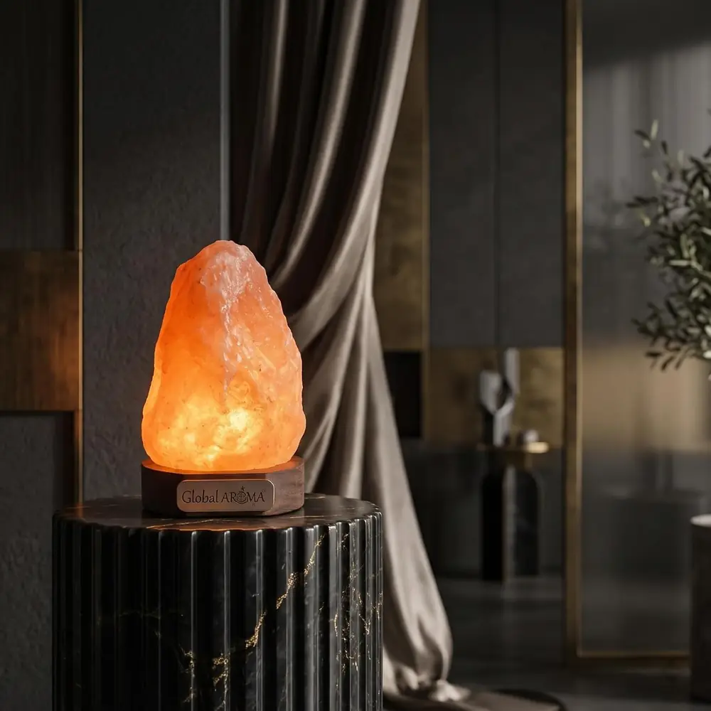 A lit salt lamp on a dark table beside a curtain