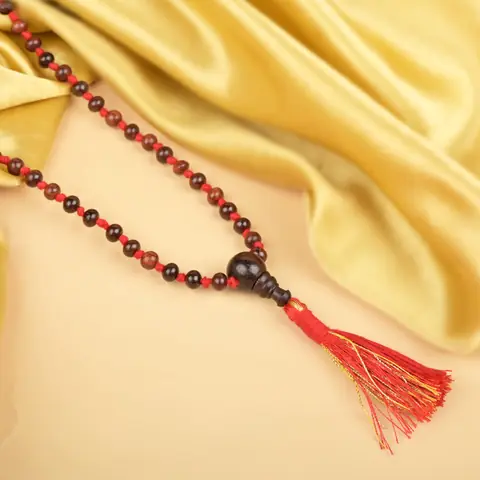 The mala on gold cloth with its tassel