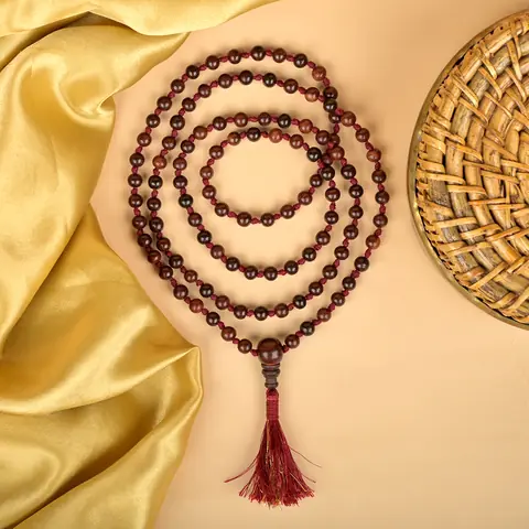 Coils of the mala on gold cloth