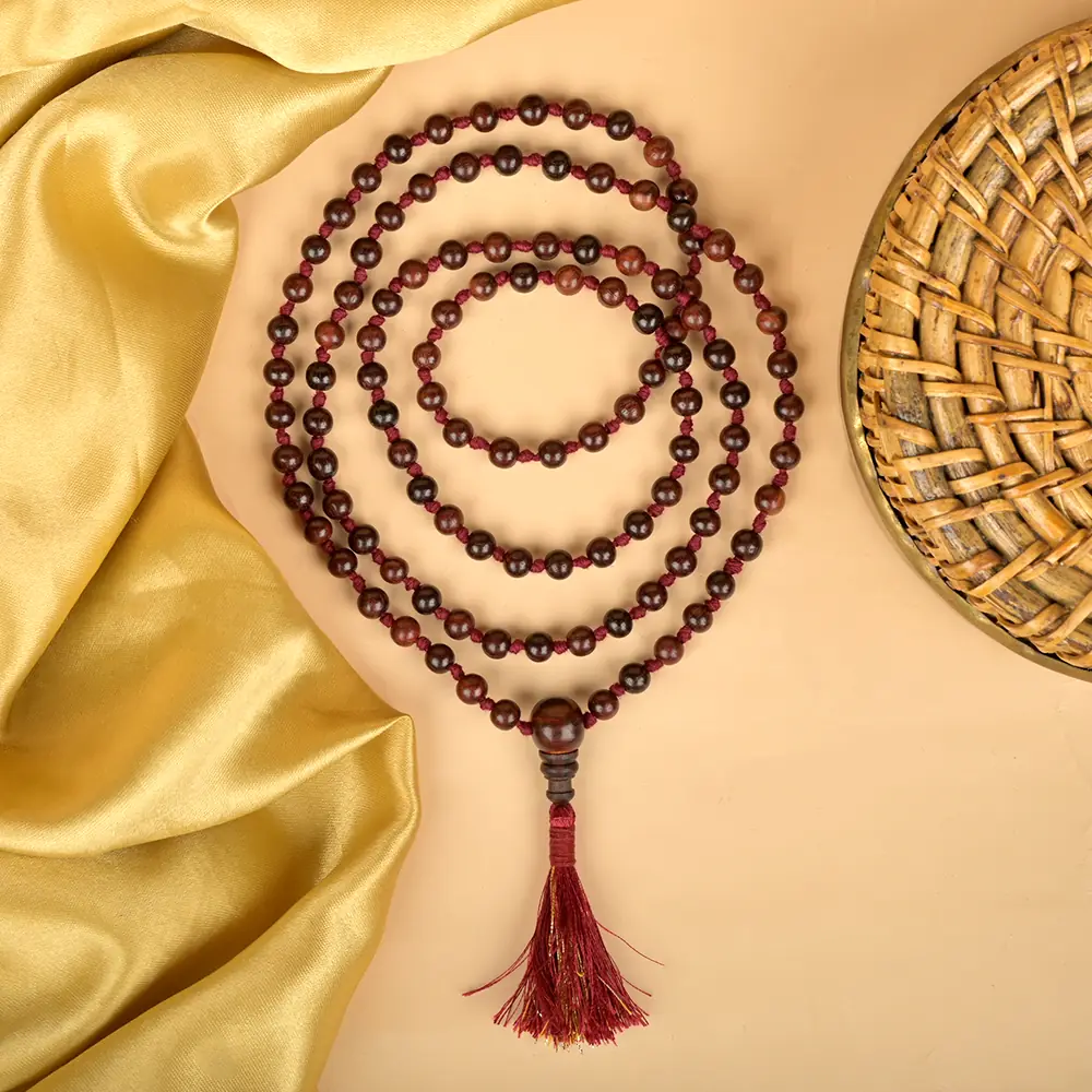 Coils of the mala on gold cloth