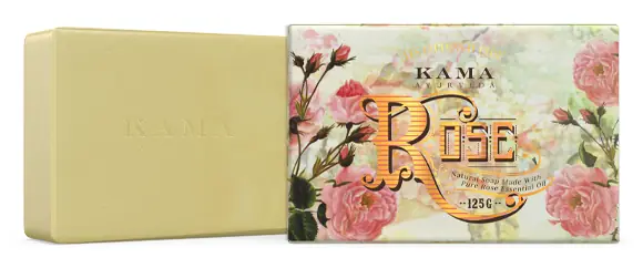 Cream coloured rose soap bar beside its rose print wrapper