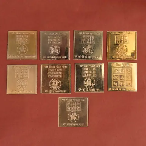 The nine gold plated yantra plates laid out
