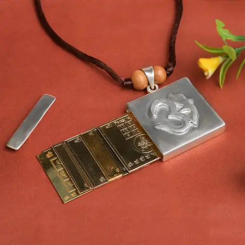 Pendant opened beside its yantra plates