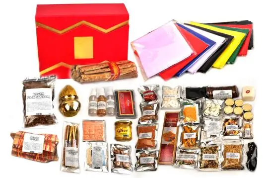 Navagraha puja kit items laid out around the red box