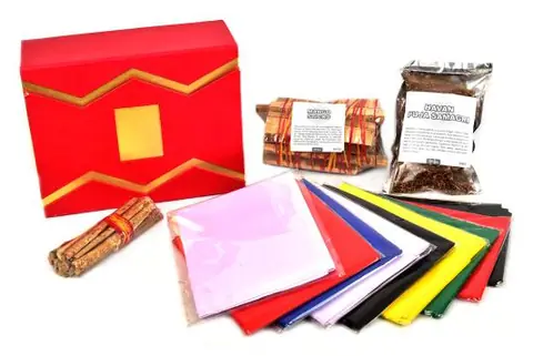 Red box with coloured altar cloths and samidha sticks