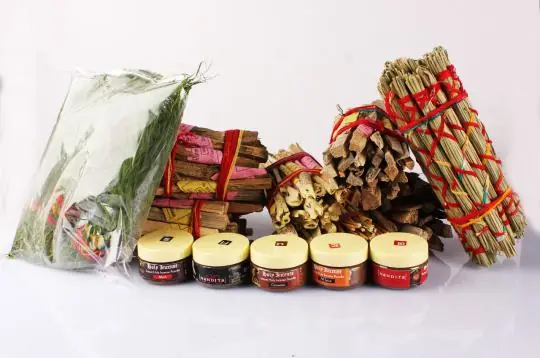 Bundles of samidha sticks with small tins of incense powder