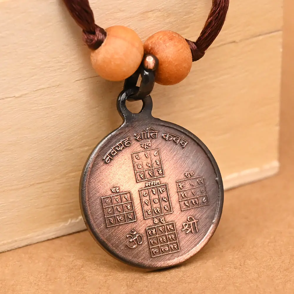 The locket at an angle, resting on a wooden box