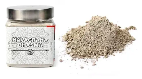 Jar of Navagraha bhasma with the powder beside it
