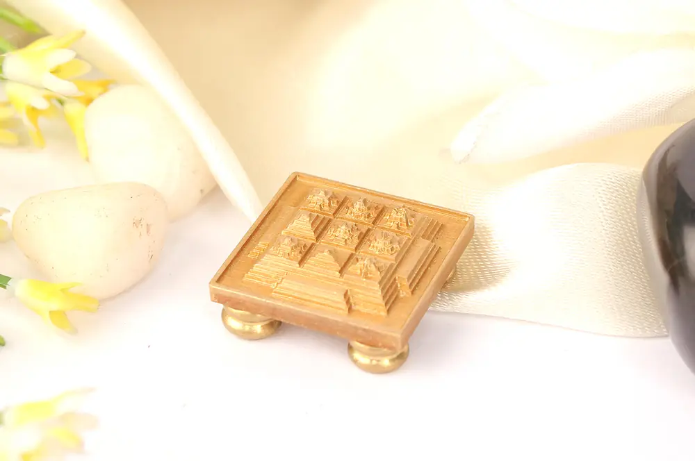 Small brass Navagraha yantra chowki on cream cloth
